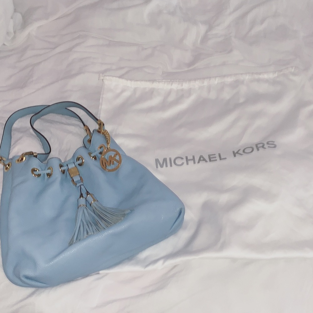 A baby blue Michael Kors purse.